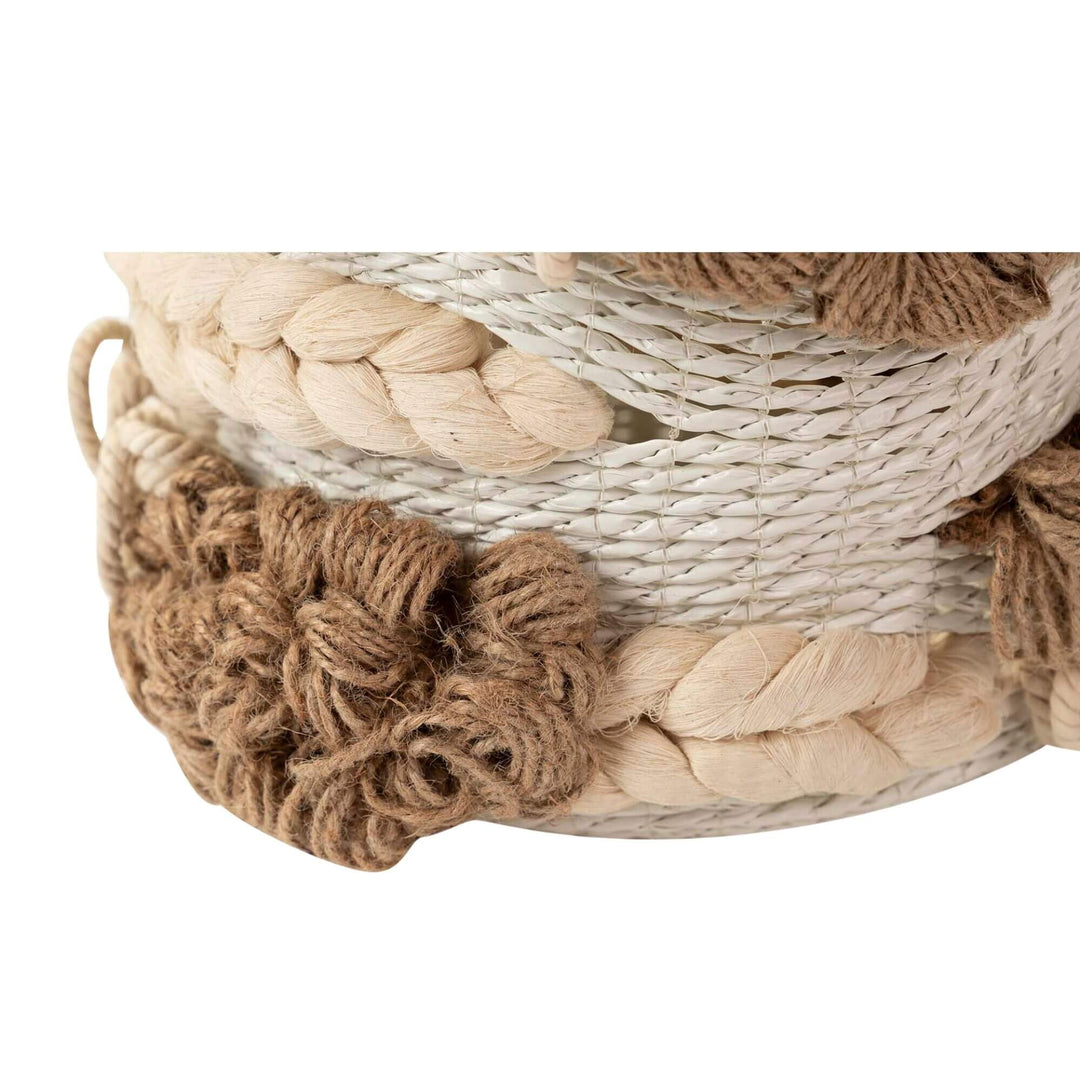 Close-up of handwoven seaweed and cotton basket with bohemian texture.