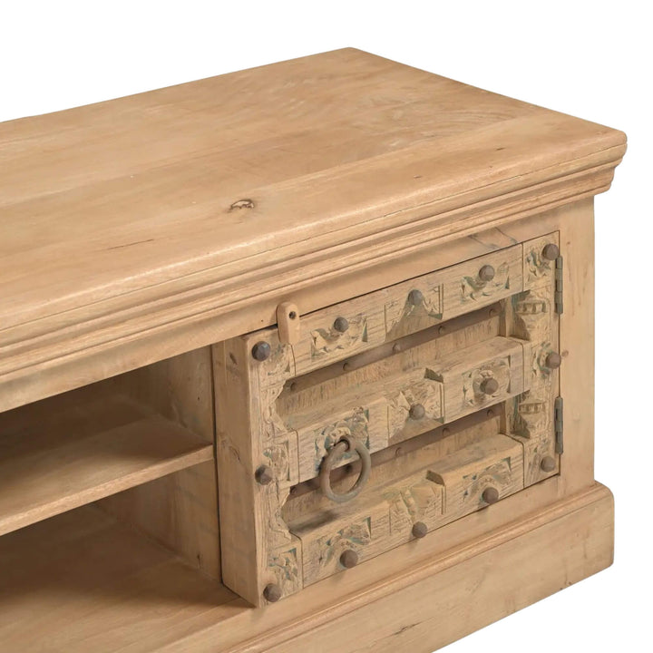 Close-up of the Aruna Briss TV console highlighting the mango wood finish and decorative vintage-style metal hardware