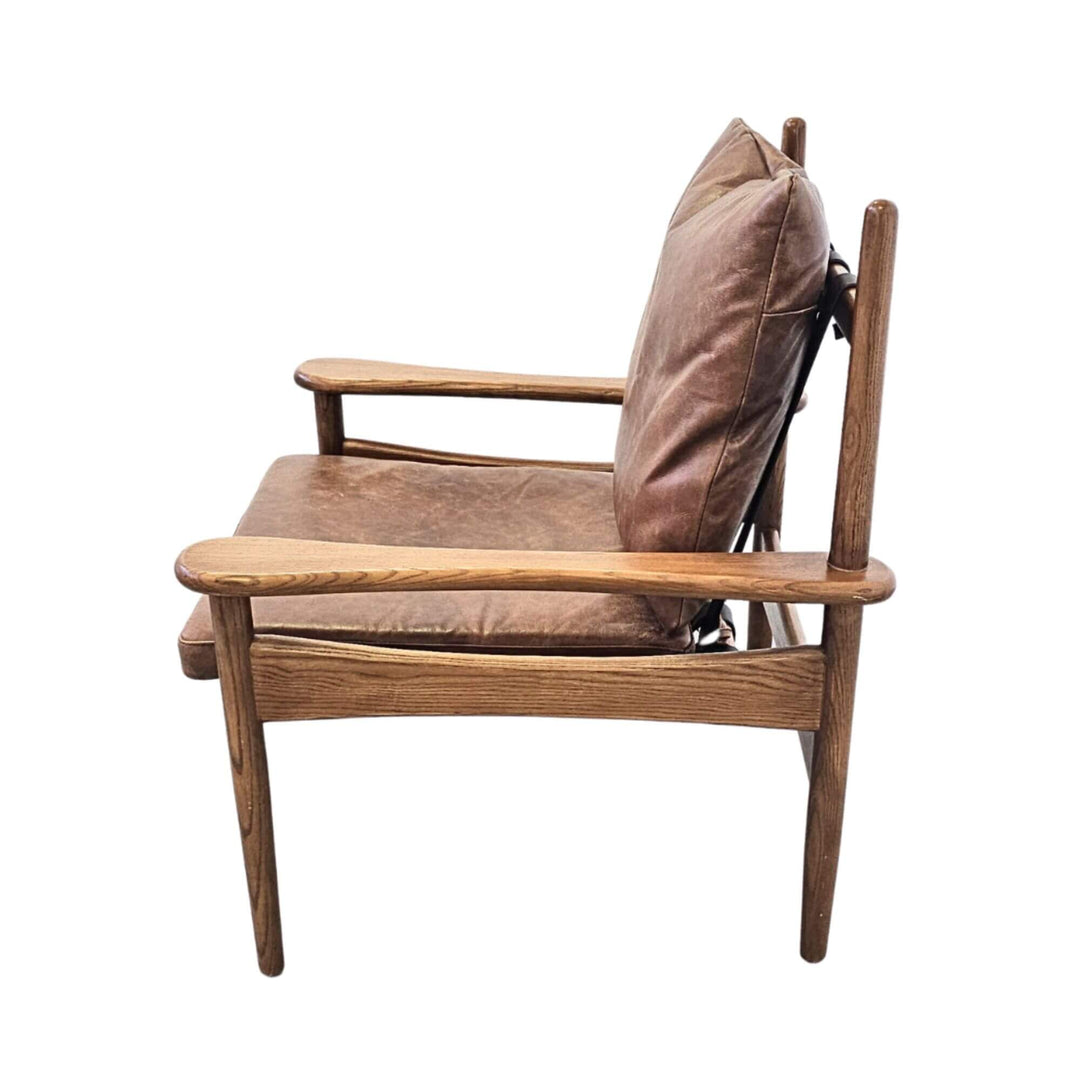 Side profile of Asikni leather and teak wood chair