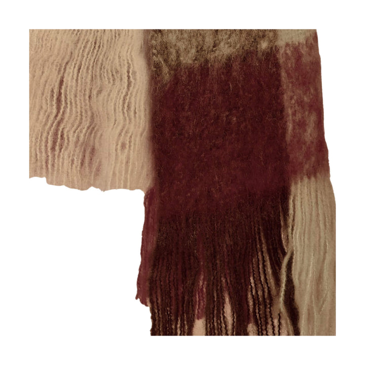 Close-up of warm Aura scarf fringes in garnet and beige tones