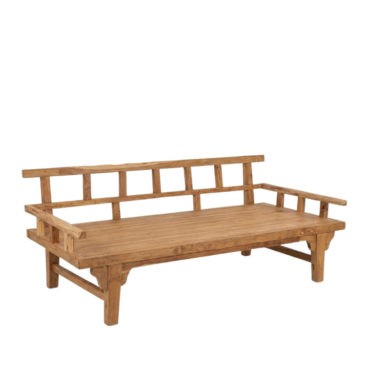 Angled view of Aurora teak wood daybed highlighting the solid wooden frame and minimalist structure.