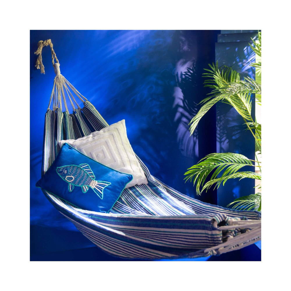Azure hammock styled in a blue tropical setting with cushions.