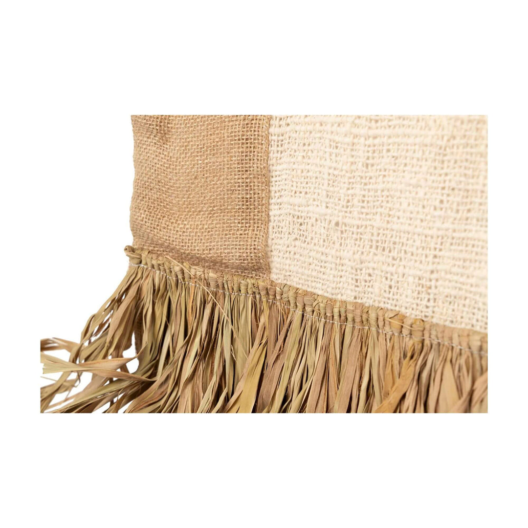 Close-up of handcrafted Badimo wall deco curtain showing woven texture and natural materials.

