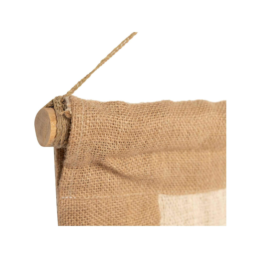 Close-up of handcrafted Badimo wall deco curtain showing woven texture and hanging cord.

