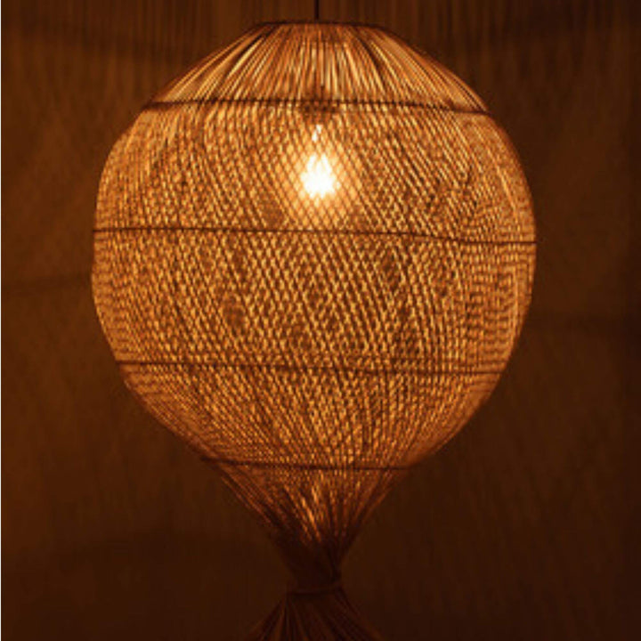 Bali Ball Lamp illuminated, showing warm ambient glow through weave.