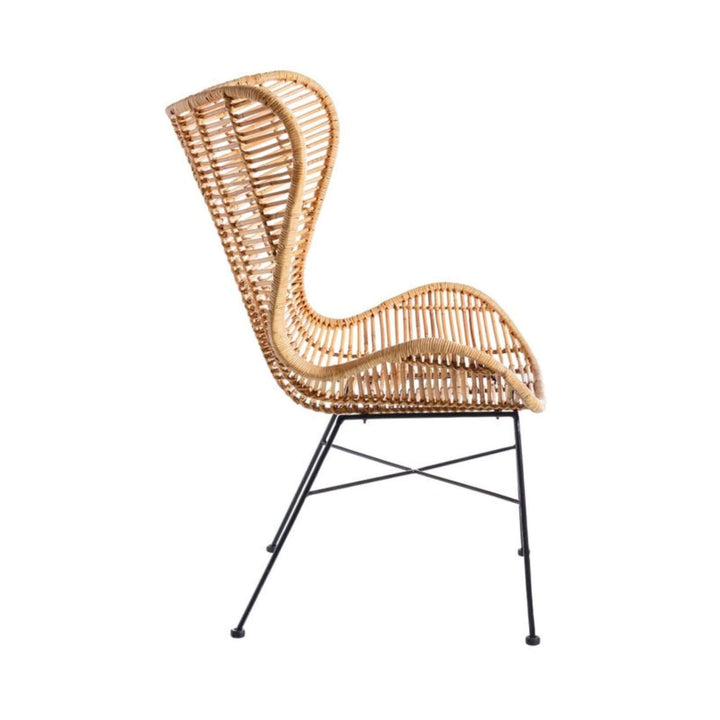 Side profile of the Bali Rattan Lounge Chair showing its curved rattan body and metal base.