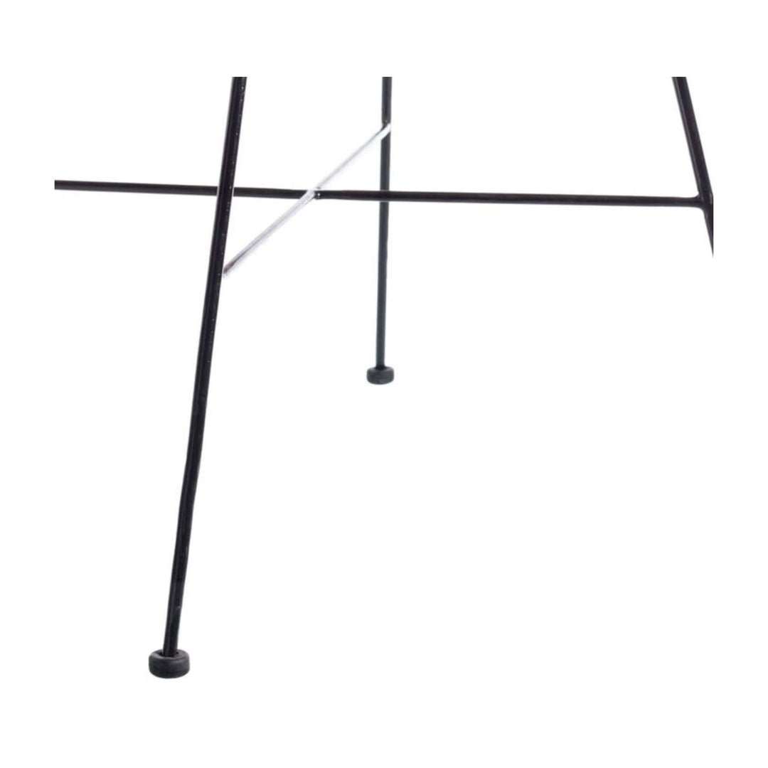 Close-up view of the black metal legs of the Bali Rattan Lounge Chair.