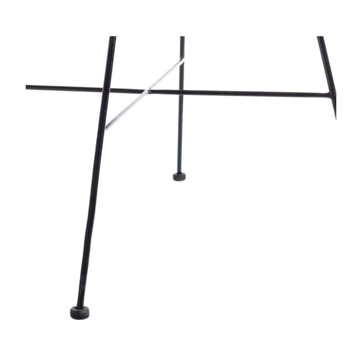 Close-up view of the black metal legs of the Bali Rattan Lounge Chair.