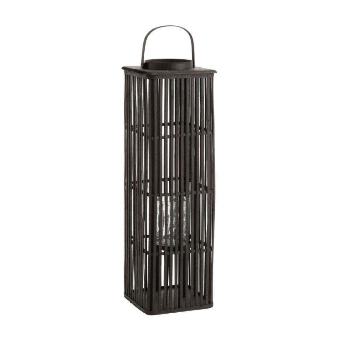 Black bamboo floor lantern showing open slatted design and internal glass candle holder.

