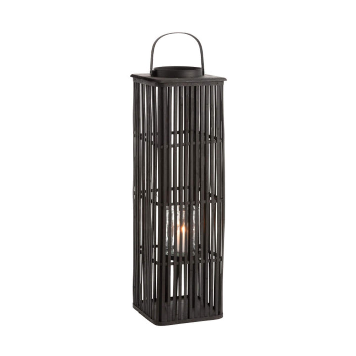 Tall rectangular black bamboo lantern with handle and lit candle inside glass holder.
