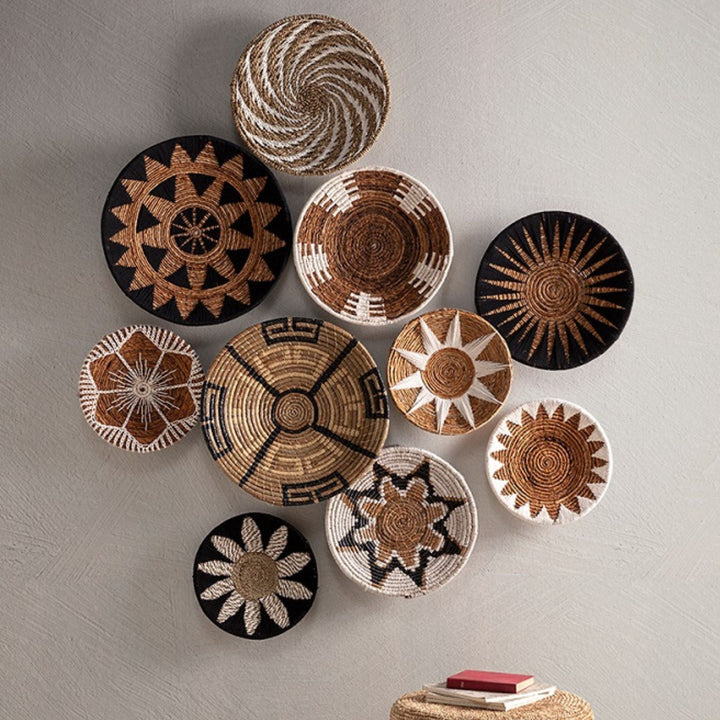 Styled wall composition featuring the Banana Deco Plate combined with other ethnic wall décor.