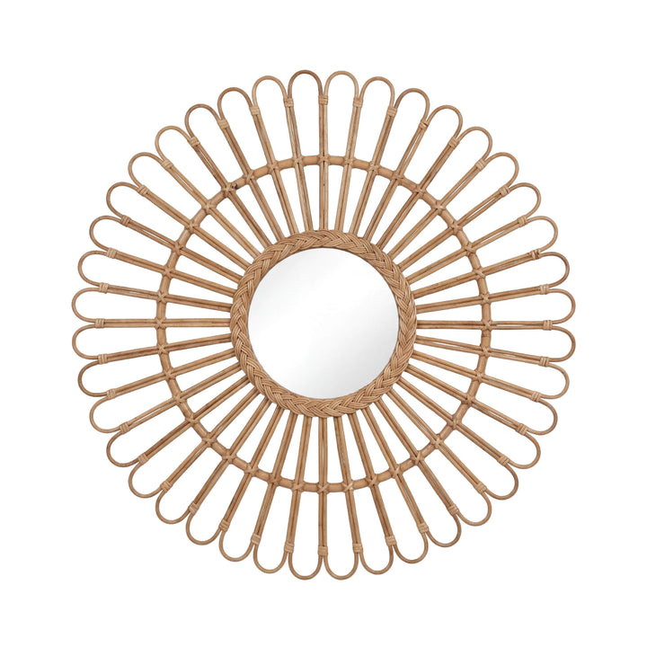 Front view of the Banana mirror showing its round center and sculptural sunburst rattan frame.