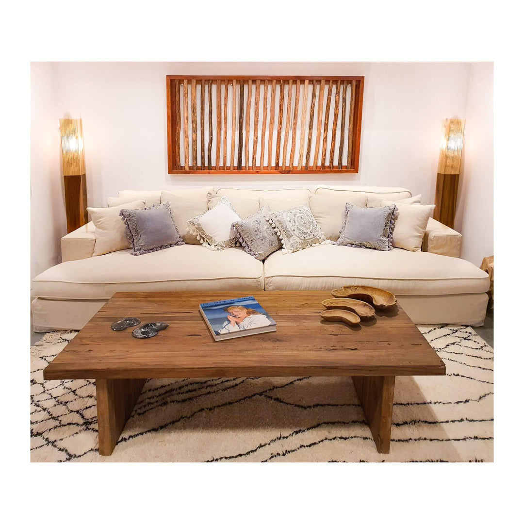 Bangalore Teak Wood panel displayed above a sofa in a modern natural living room.

