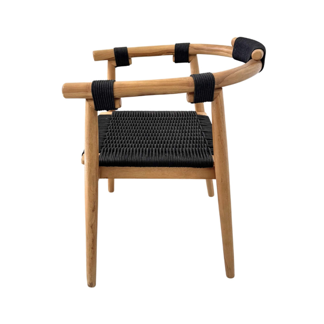 Side profile of Baros Dining Chair with slim teak legs and flat woven rope seat.