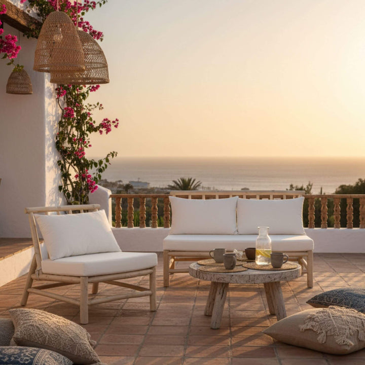 Outdoor terrace scene featuring the Batang teak-branch sofa without armrest.