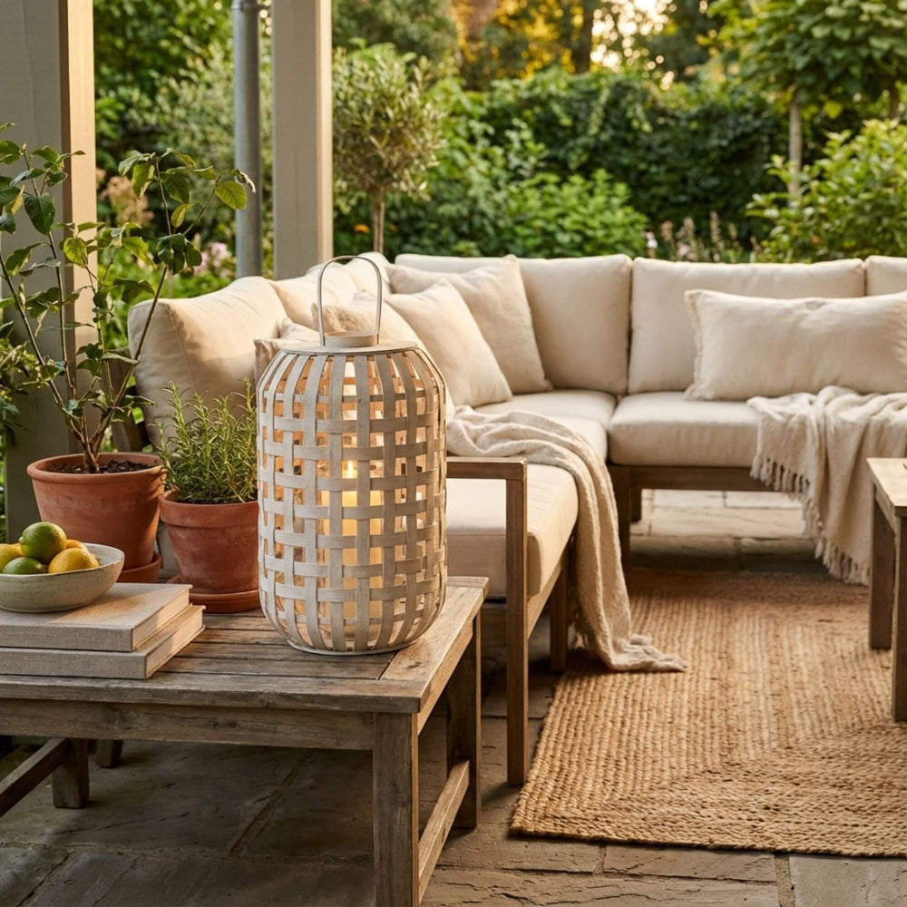 Styled interior setting featuring the Beach lantern placed on a wooden coffee table with soft ambient light.