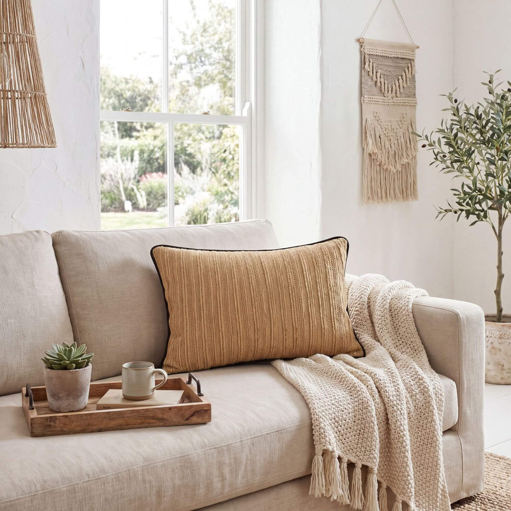 Styled interior setting featuring the Beach Natural cushion on a sofa with soft neutral textiles.