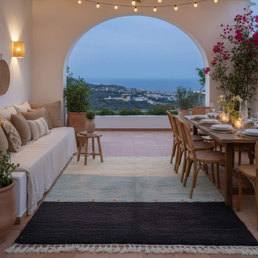 Outdoor living space featuring the Beni Ourain Rug next to a dining setup with soft lighting.