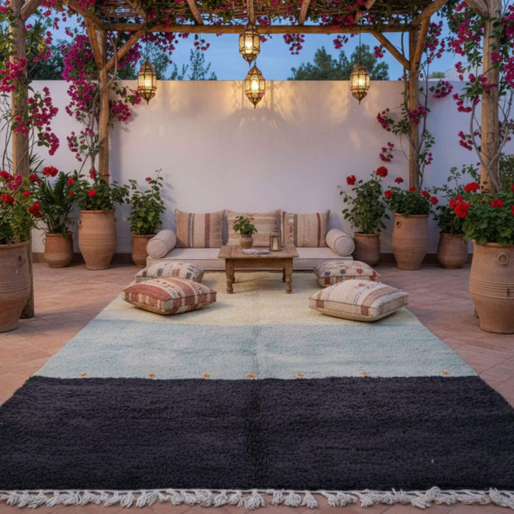 Cozy terrace with cushions showcasing the Beni Ourain Rug in soft natural tones.