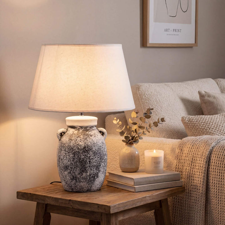 Styled bedside setting featuring the Bianca table lamp adding warm ambient light to a cozy interior.