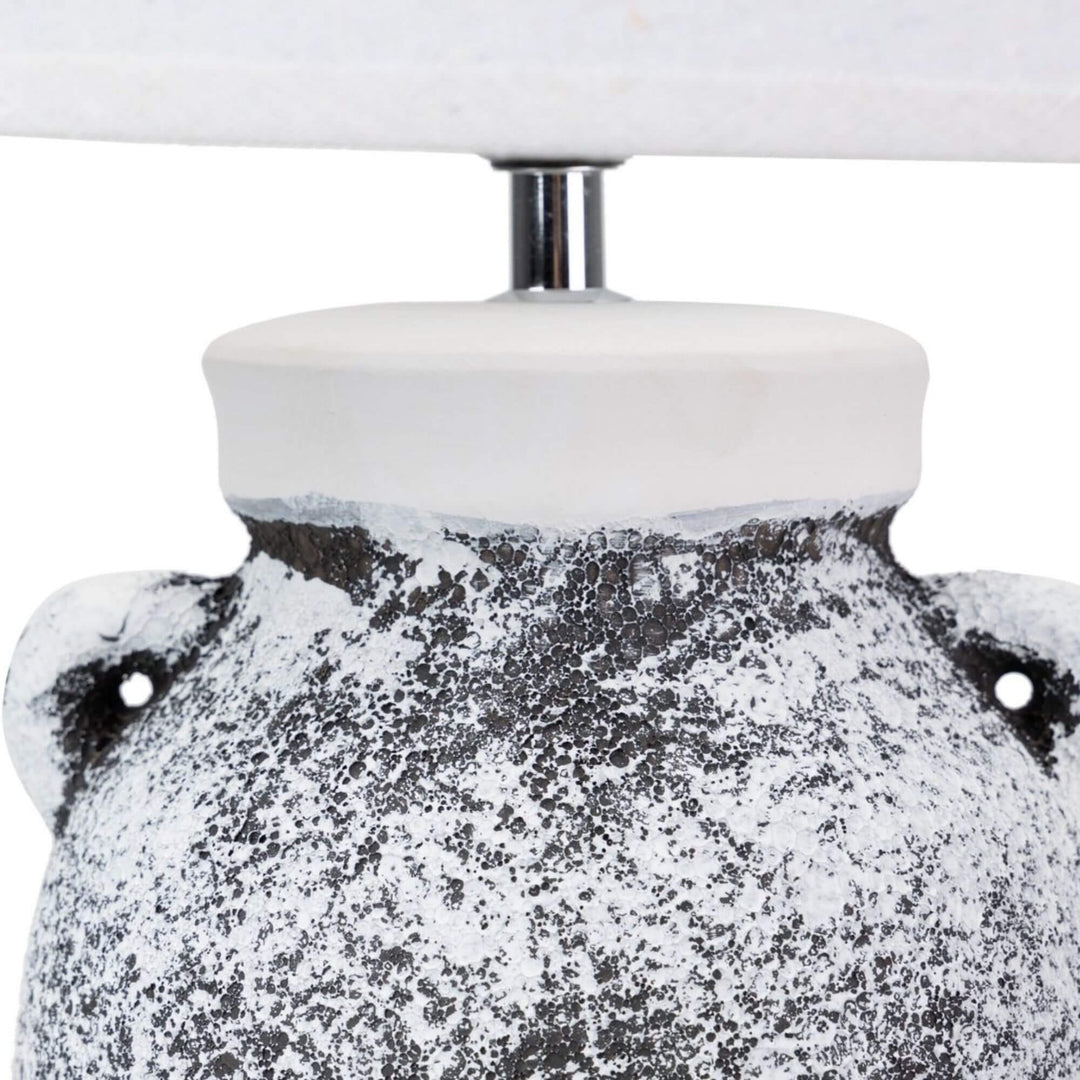 Close-up of the upper ceramic base showing the textured black-and-white finish and rounded shape.