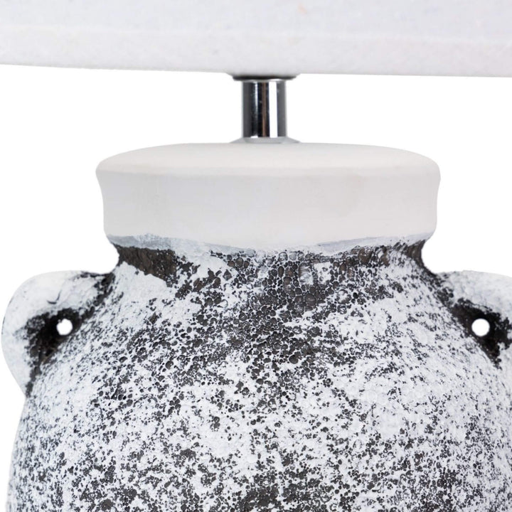 Close-up of the upper ceramic base showing the textured black-and-white finish and rounded shape.