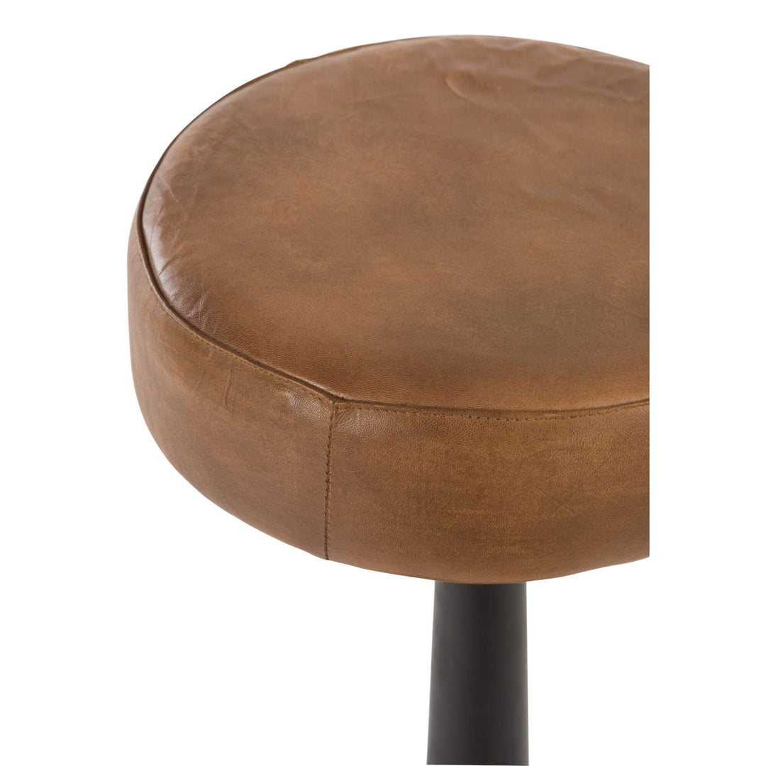 Close-up of the round brown leather seat of the Bill Bar Stool.