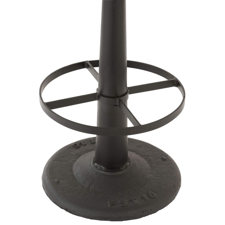 Close-up of the black iron base and footrest of the Bill Bar Stool.