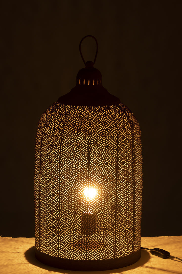 Birds table lamp glowing in a dark room with patterned light effect.