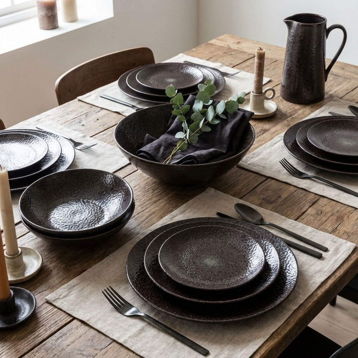 Black Basalte basalt plates and bowls styled on a rustic dining table.
