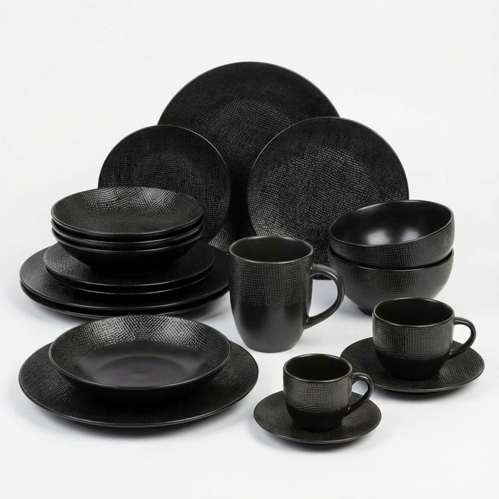 Black Vesuvio ceramic tableware set with plates, bowls, cups, and mugs.
