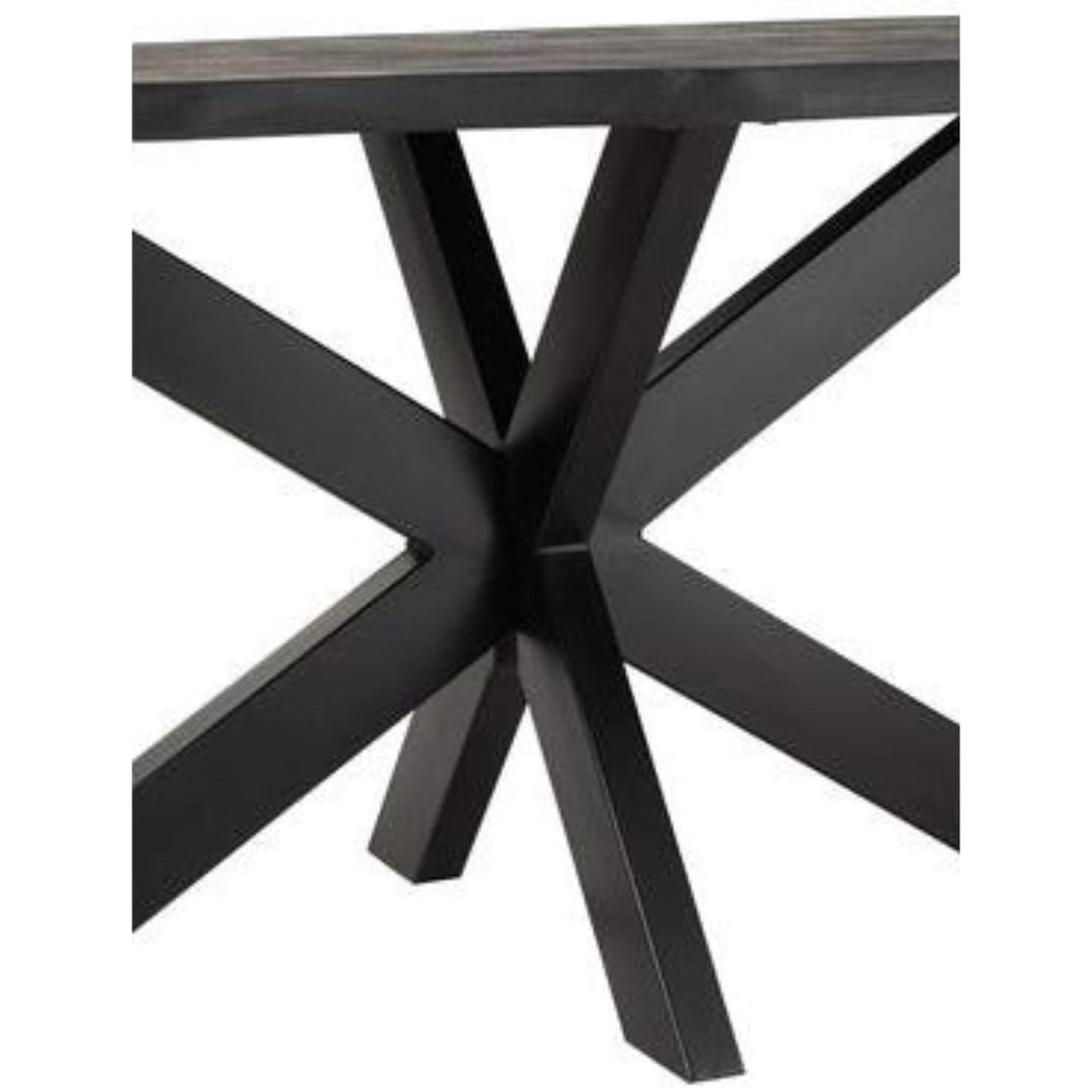 Close-up of the Black Acacia Dining Table base with crossed metal legs.