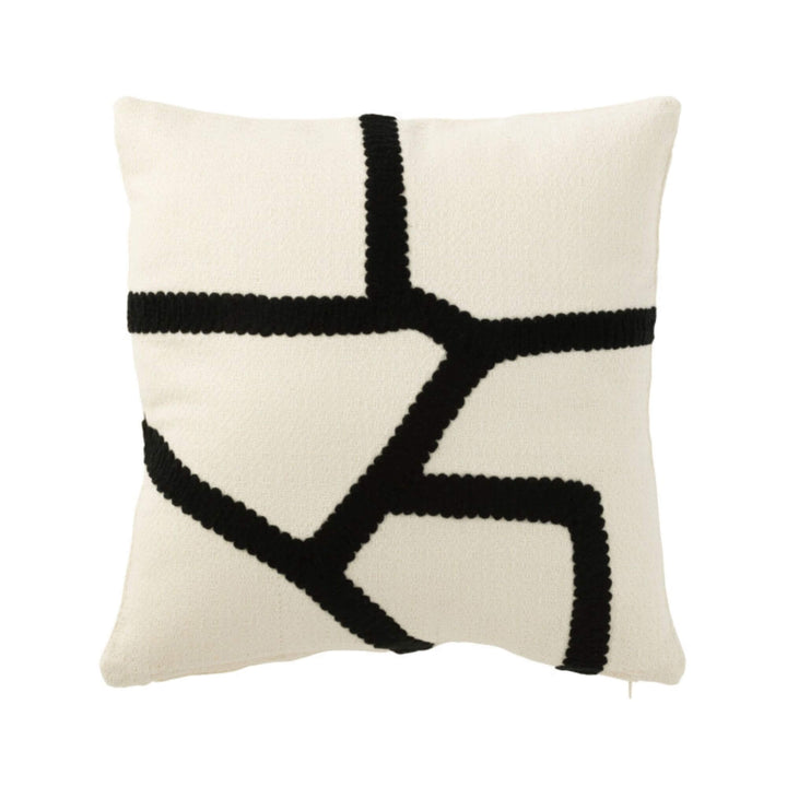 B&W cushion front view with black geometric embroidery.