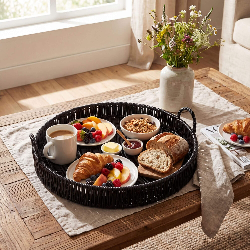 Styled table setting featuring the black round tray used for serving breakfast and drinks.