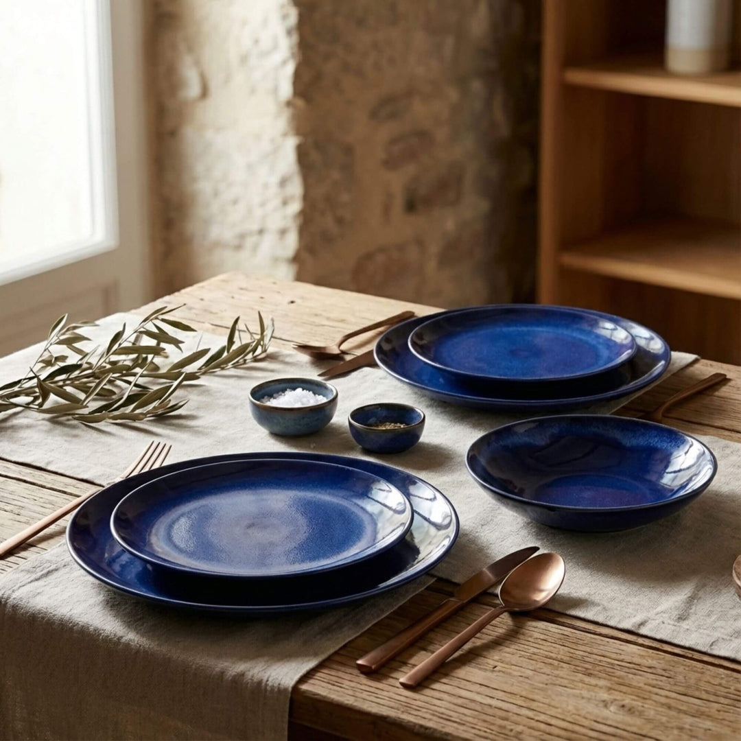 Blue Eye tableware plates and bowls styled on a rustic dining table.