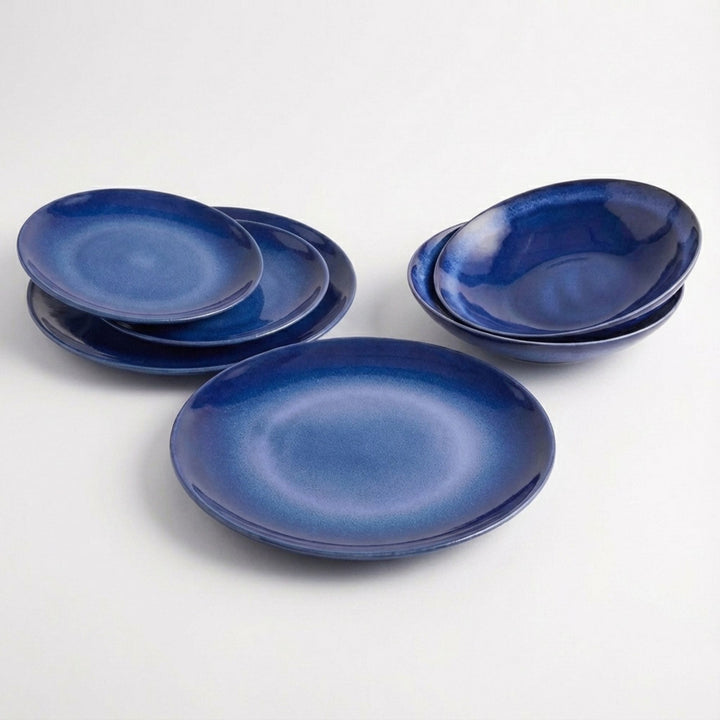 Set of Blue Eye ceramic tableware pieces with deep blue glazed finish on white background.