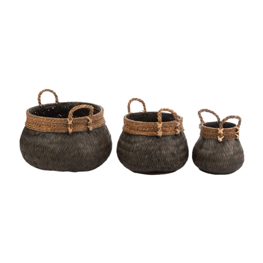 Trio of black rattan baskets displayed together in varying sizes