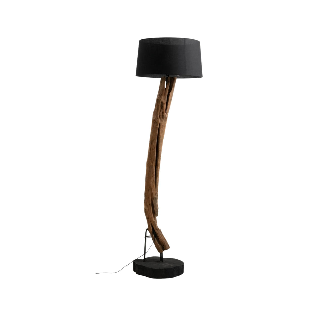 Front view of Boatu Floor Lamp with sculptural teak wood structure and black fabric lampshade on a round base.