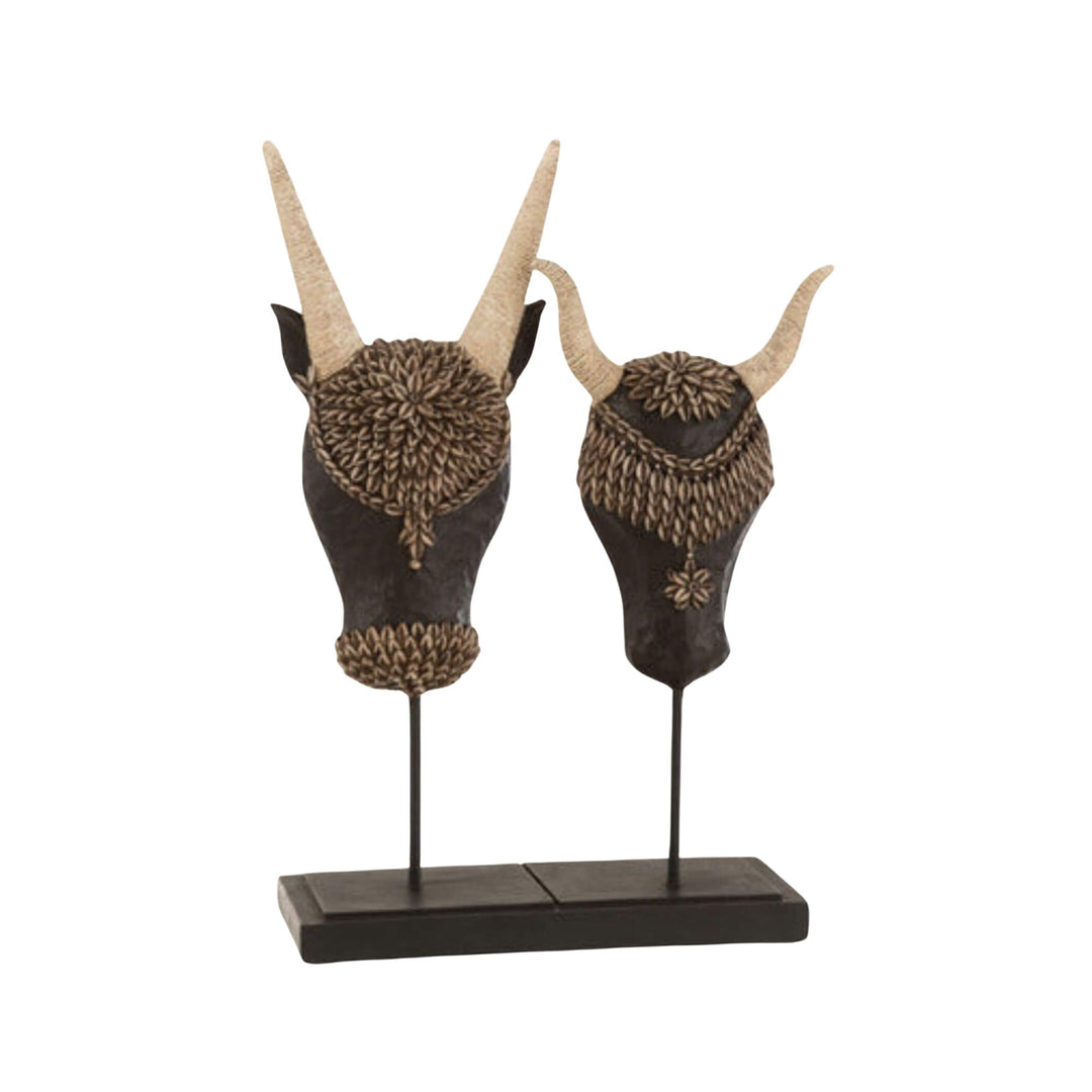 Two decorative animal Boho bull double stand on a stand against a white background