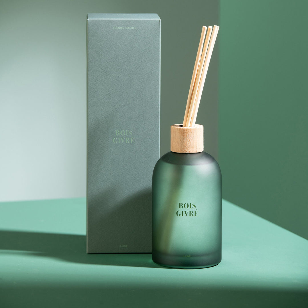 Diffuser styled on a green-toned interior setting with its matching box.
