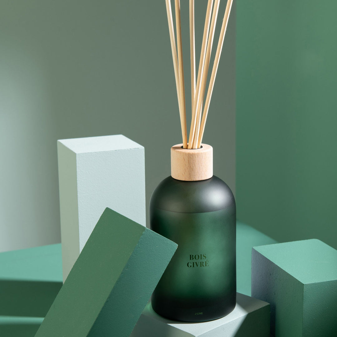 Diffuser styled on a green-toned interior setting with its matching box.