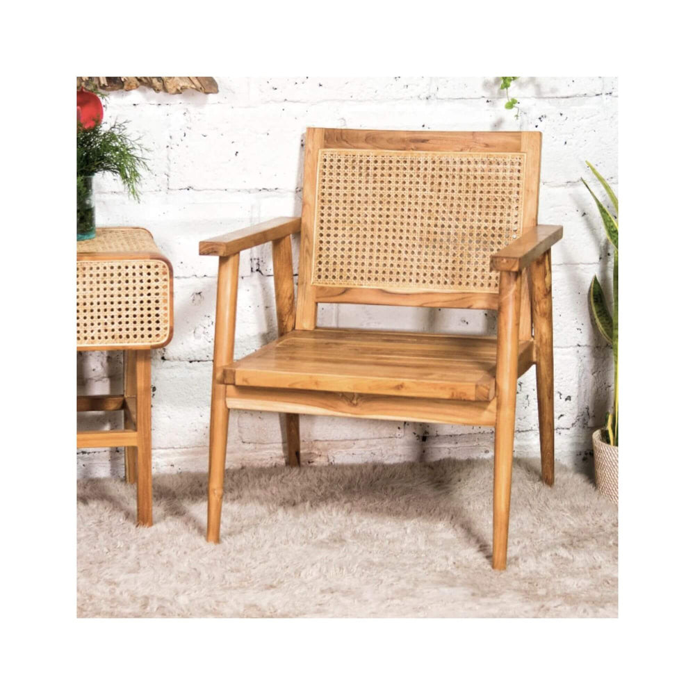 Bora Bora armchair showing solid teak frame and woven rattan backrest in a styled interior setting.