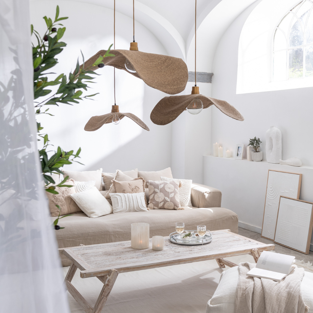 Boucan ceiling jute lamp hanging over a natural living room with wooden furniture.