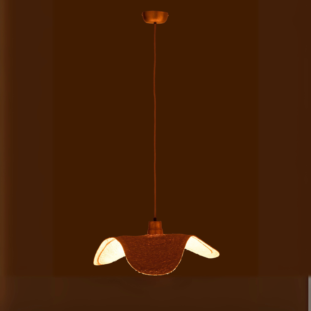 Boucan ceiling lamp illuminated in a dark room creating warm ambient glow.
