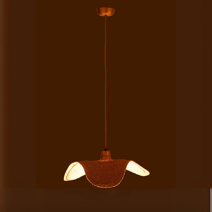 Boucan ceiling lamp illuminated in a dark room creating warm ambient glow.