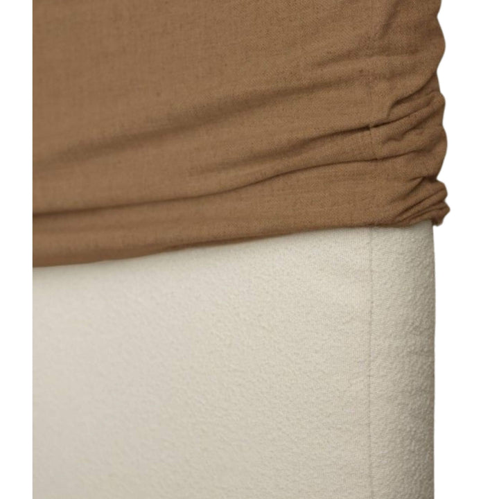 Close-up detail of the bouclé fabric highlighting its tactile texture and neutral tone.