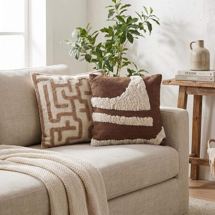 Styled sofa setting featuring the Brenda cushion in a warm natural living space.