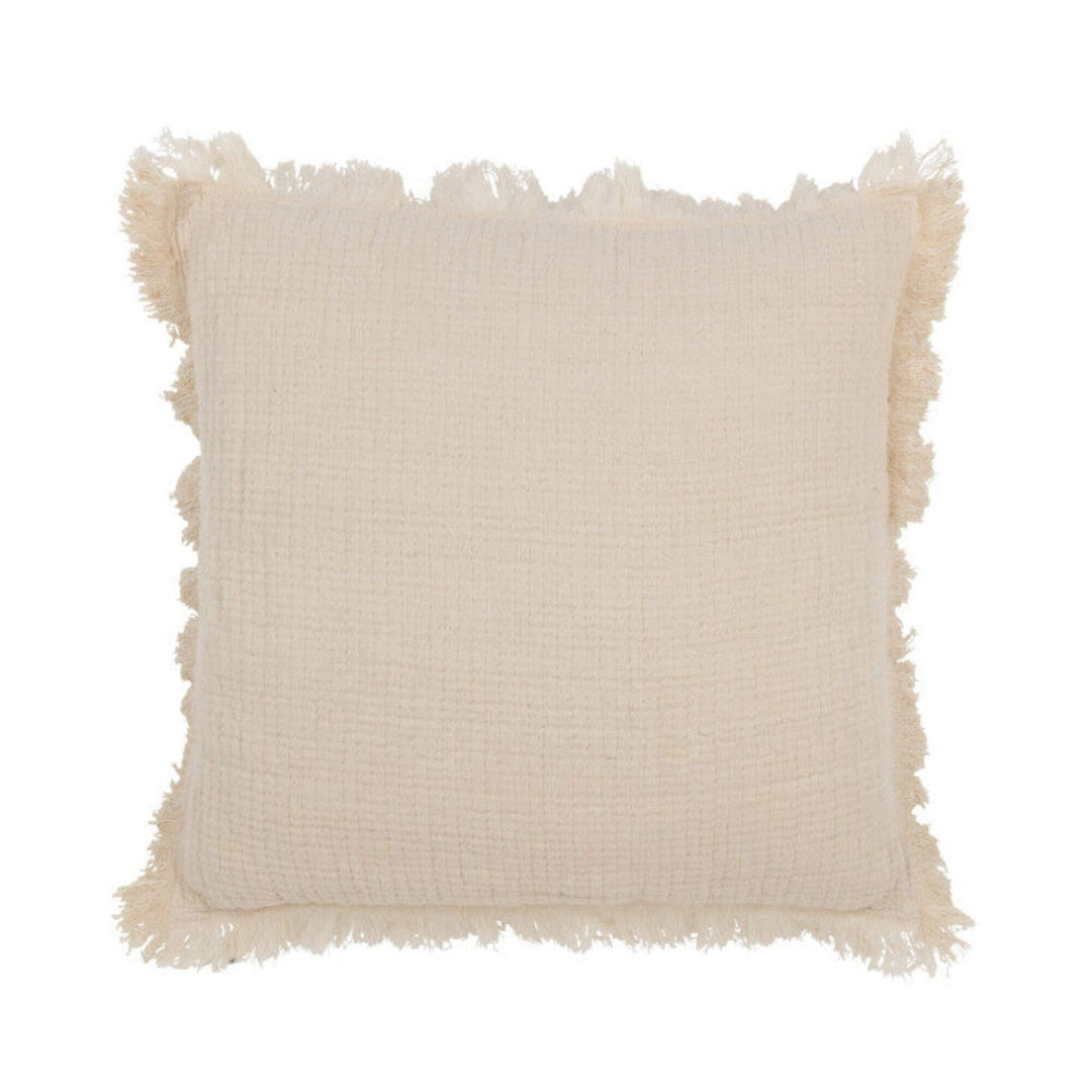 Brisa Cushion Cream front view showing textured cotton surface and fringed border.