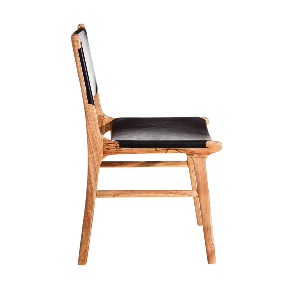 Side profile of teak and leather dining chair highlighting seat and back proportions.