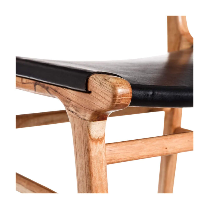 Detail of teak wood seat frame and black leather seat connection.